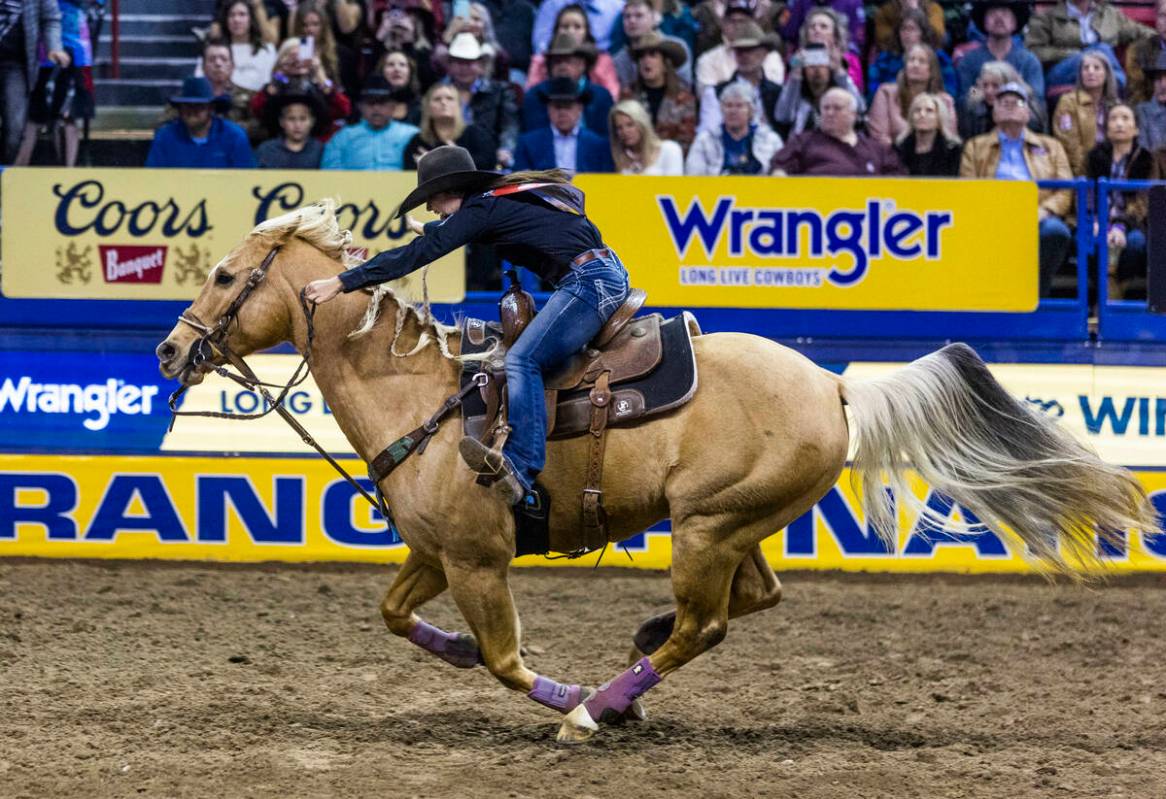 Hailey Kinsel of Cotulla, Texas, races home on the way to her winning time in Barrel Racing dur ...