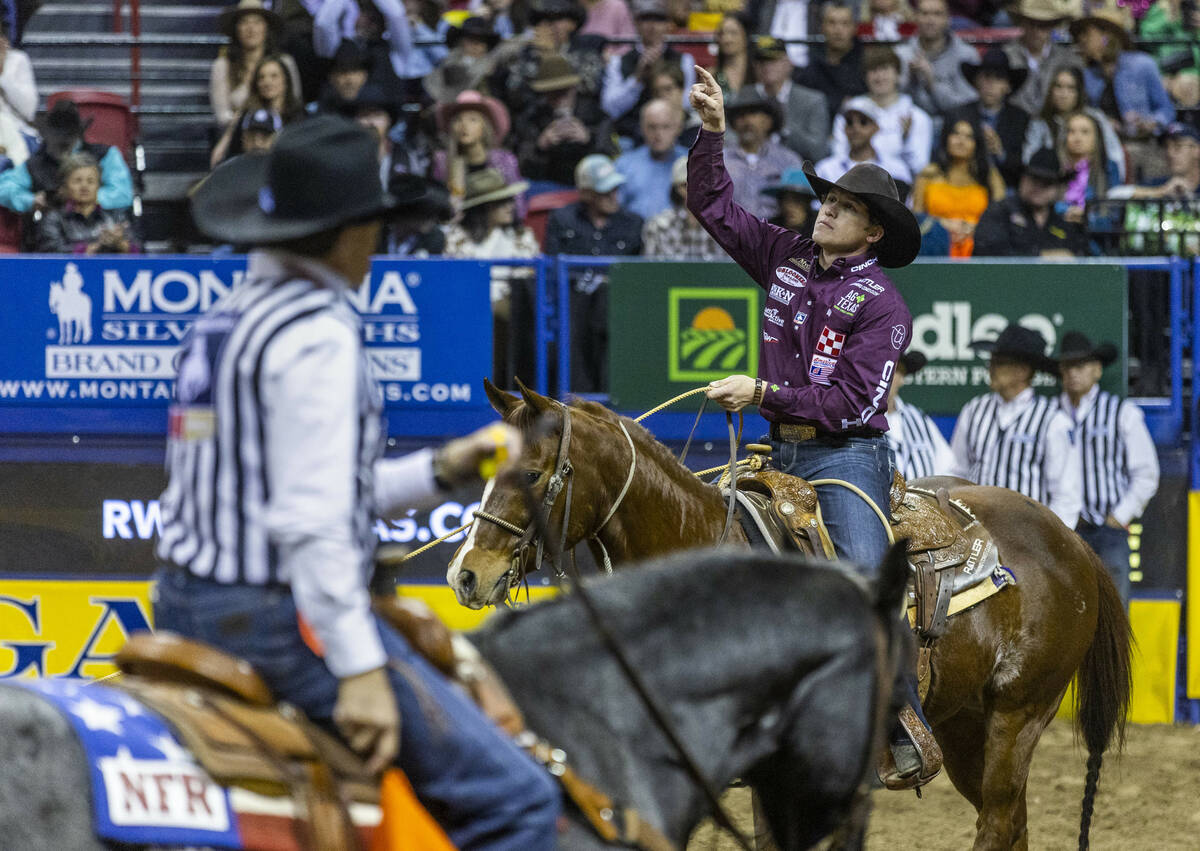 Marty Yates of Stephenville, Texas, points a winning time in Tie-Down Roping during the Nationa ...