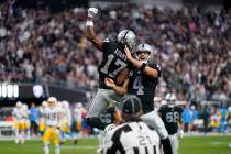 Las Vegas Raiders quarterback Derek Carr (4) and wide receiver Davante Adams (17) celebrate the ...