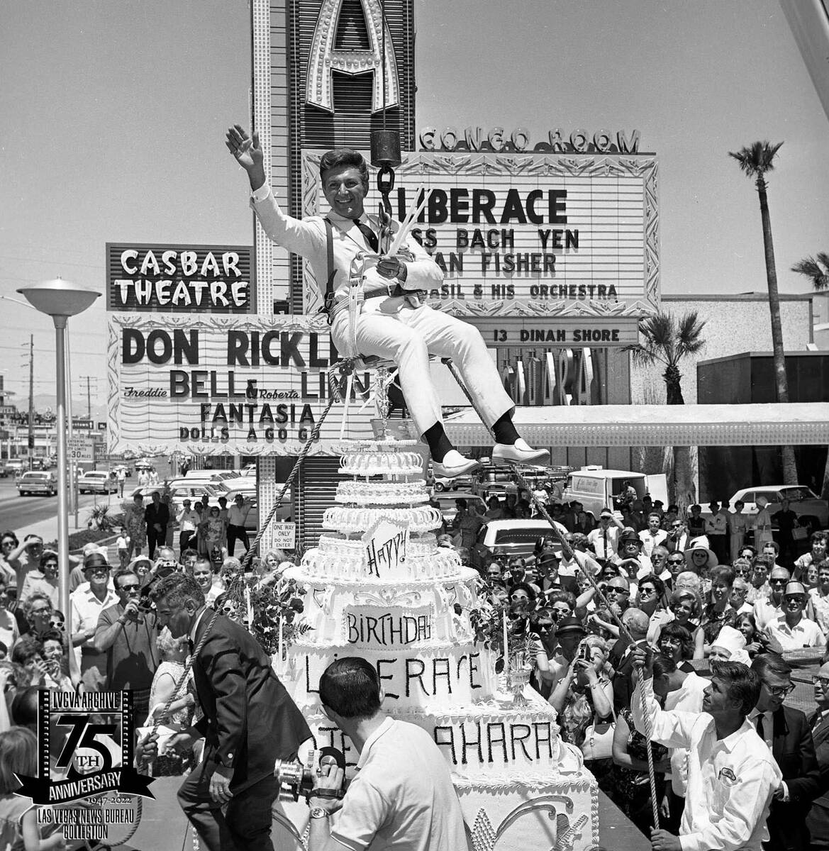 Liberace hanging above his birthday cake in front of the Sahara on May 16, 1967. The publicity ...