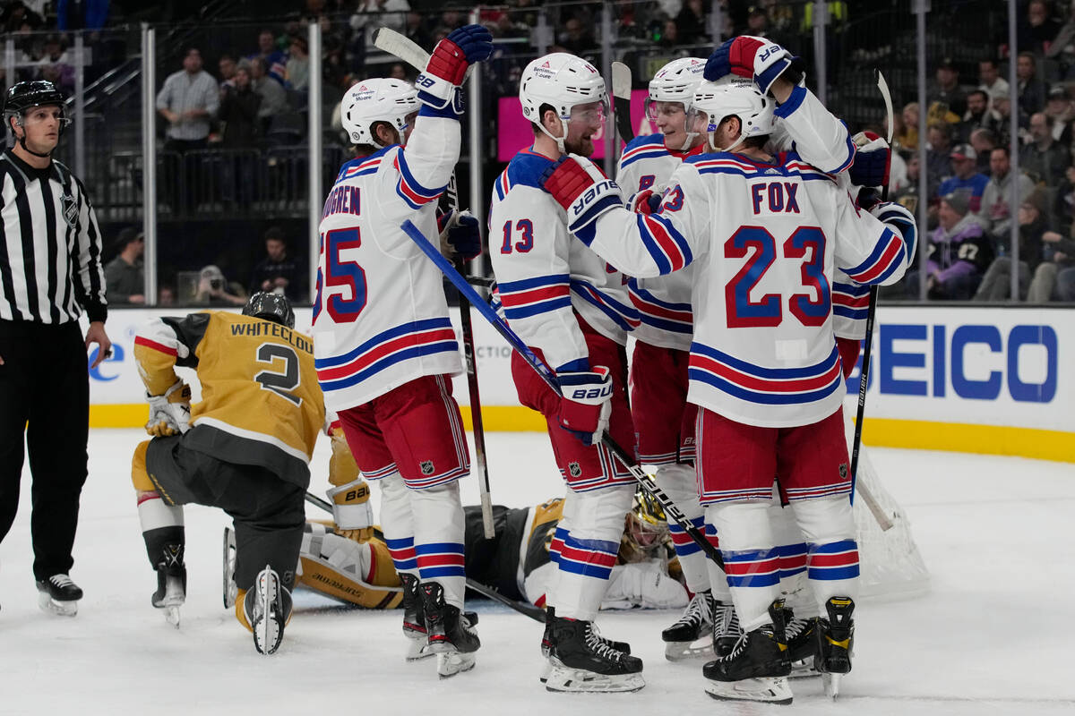 New York Rangers left wing Alexis Lafrenière (13) celebrates with teammates after scoring ...