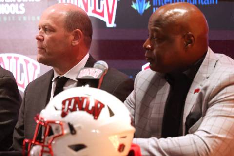 New UNLV football coach Barry Odom, center, is introduced with President Keith Whitfield, left, ...