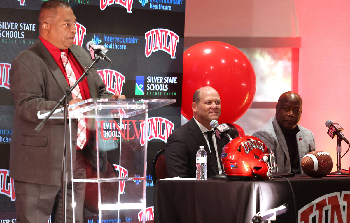 New UNLV football coach Barry Odom, center, is introduced with President Keith Whitfield, left, ...