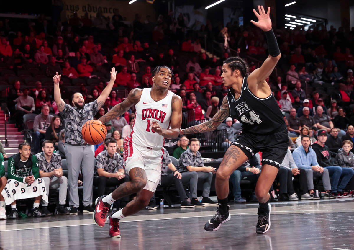 UNLV Rebels guard Luis Rodriguez (15) drives to the basket against Hawaii Warriors forward Kama ...