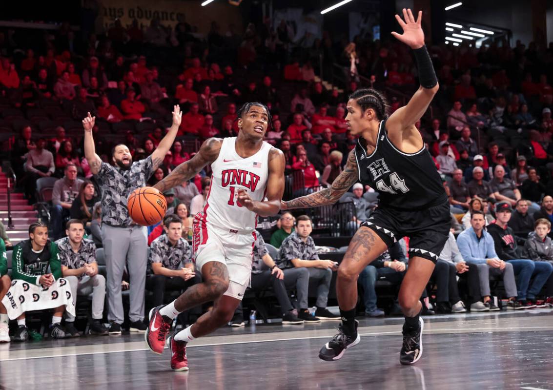 UNLV Rebels guard Luis Rodriguez (15) drives to the basket against Hawaii Warriors forward Kama ...