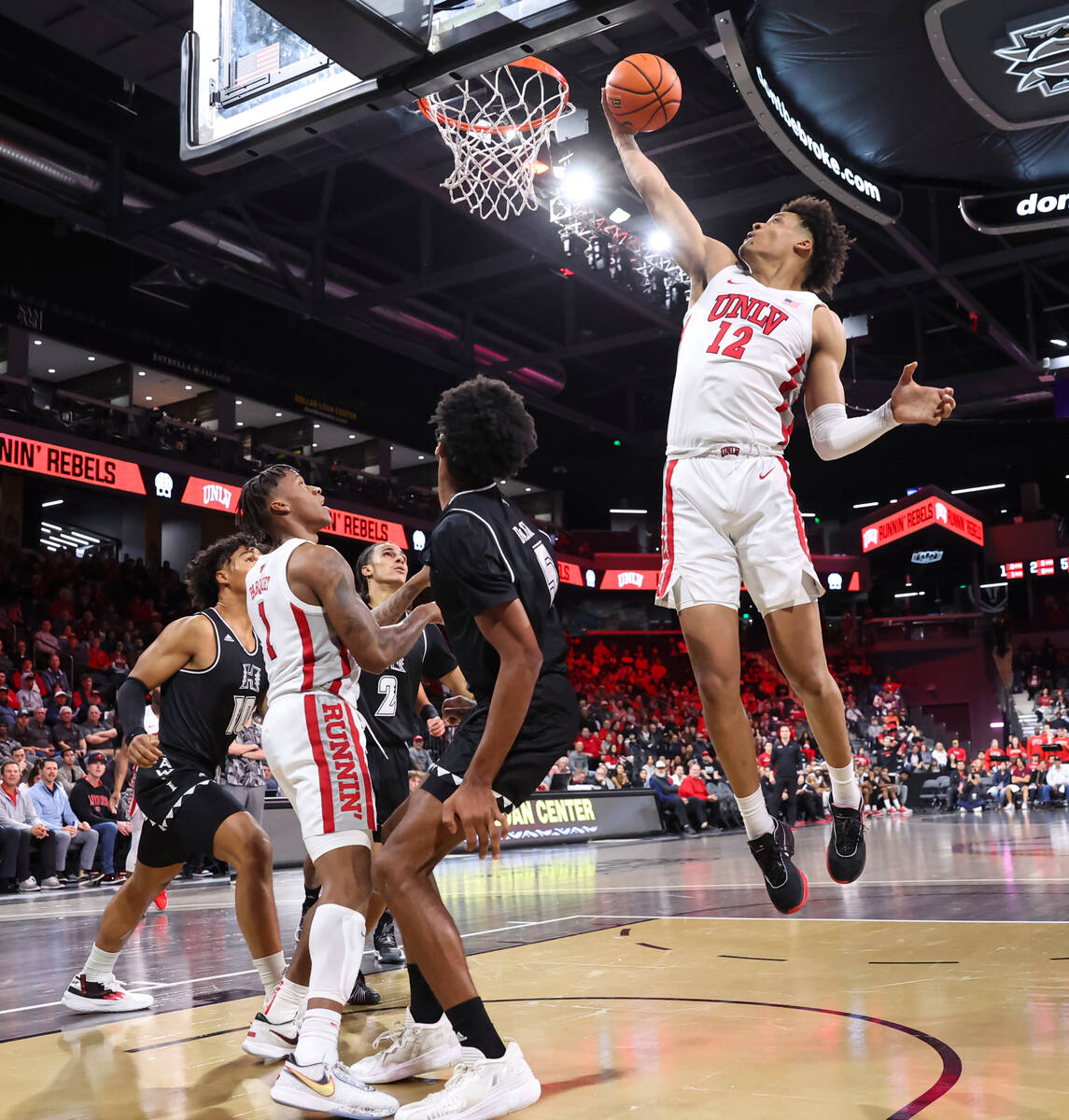 UNLV Rebels center David Muoka (12) jumps for the rebound against Hawaii during the first half ...