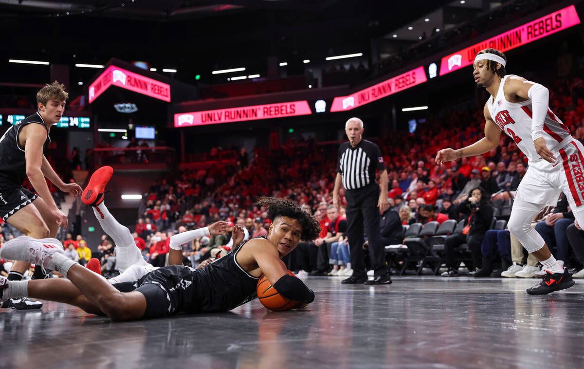 Hawaii Warriors guard Beon Riley (10) grabs a loose ball in front of UNLV Rebels guard Justin W ...