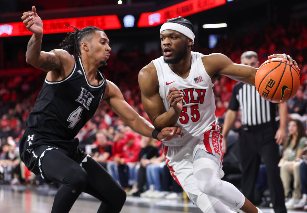 UNLV Rebels guard EJ Harkless (55) drives the ball against Hawaii Warriors guard Noel Coleman ( ...