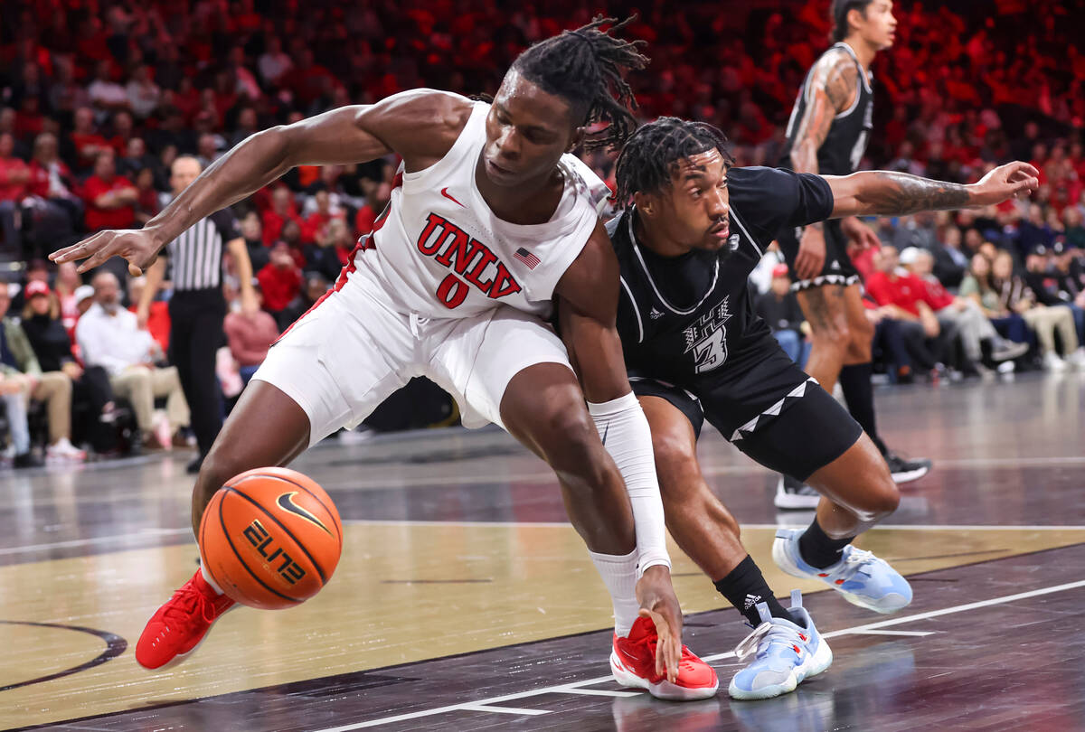 UNLV Rebels forward Victor Iwuakor (0) and Hawaii Warriors guard JoVon McClanahan (3) battle fo ...