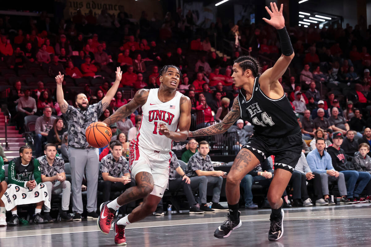 UNLV Rebels guard Luis Rodriguez (15) drives to the basket against Hawaii Warriors forward Kama ...
