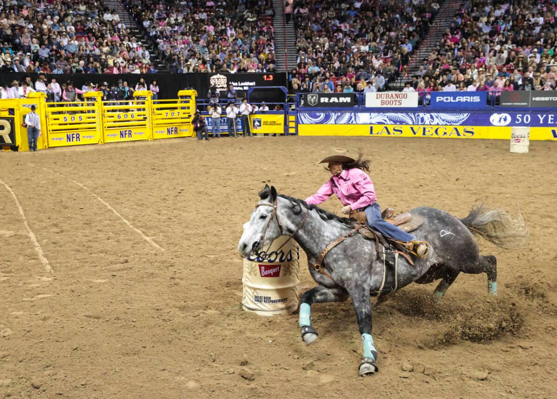 Lisa Lockhart, of Oelrichs, S.D., competes in barrel racing during the fifth go-round of the Na ...