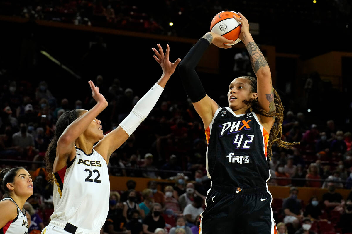 Phoenix Mercury center Brittney Griner (42) shoots over Las Vegas Aces forward A'ja Wilson (22) ...