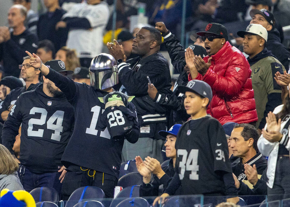 Raiders fans cheer during the first half of an NFL game against the Los Angeles Rams at SoFi St ...
