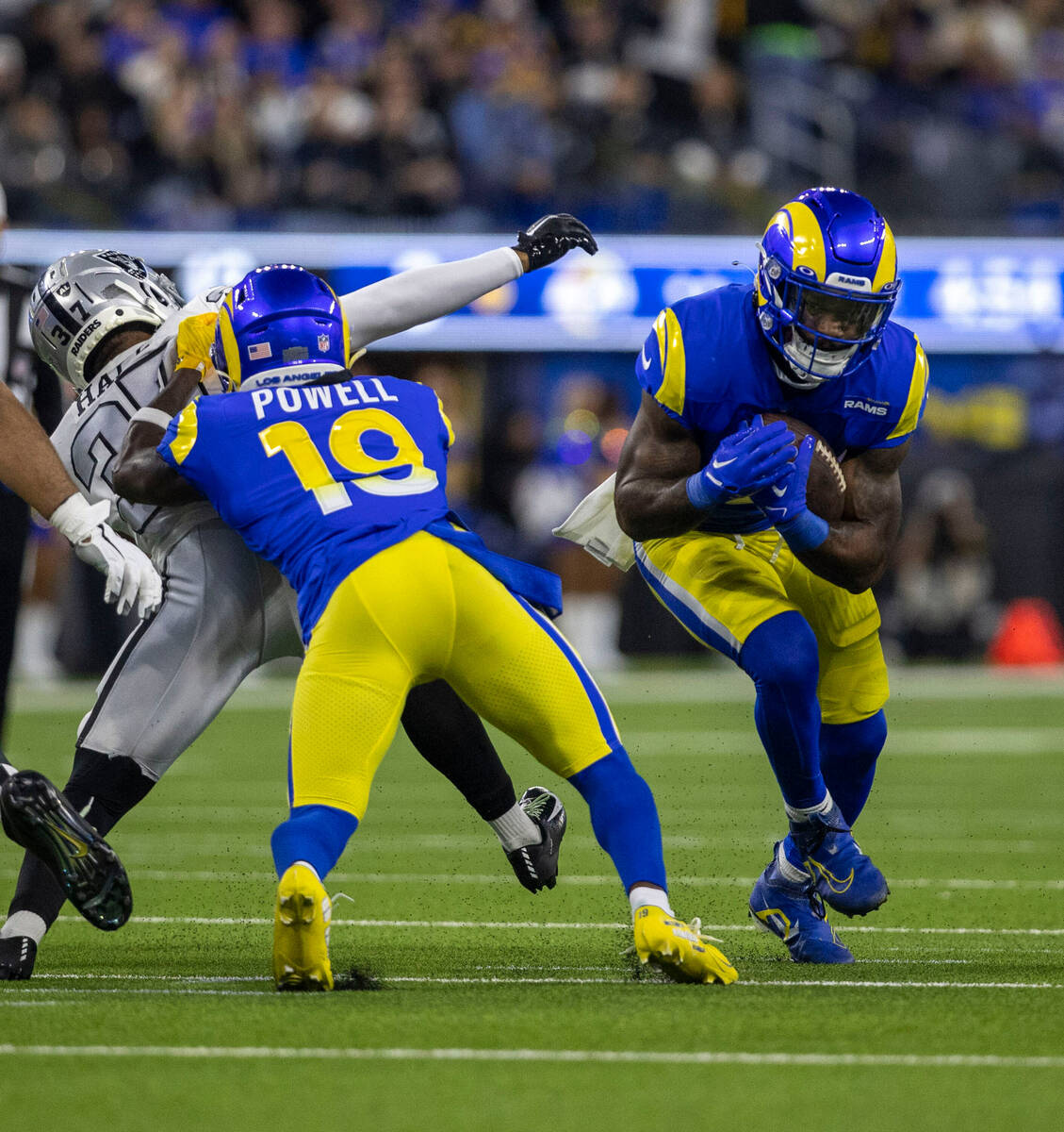 Los Angeles Rams running back Cam Akers (3) rushes with the football against Raiders cornerback ...