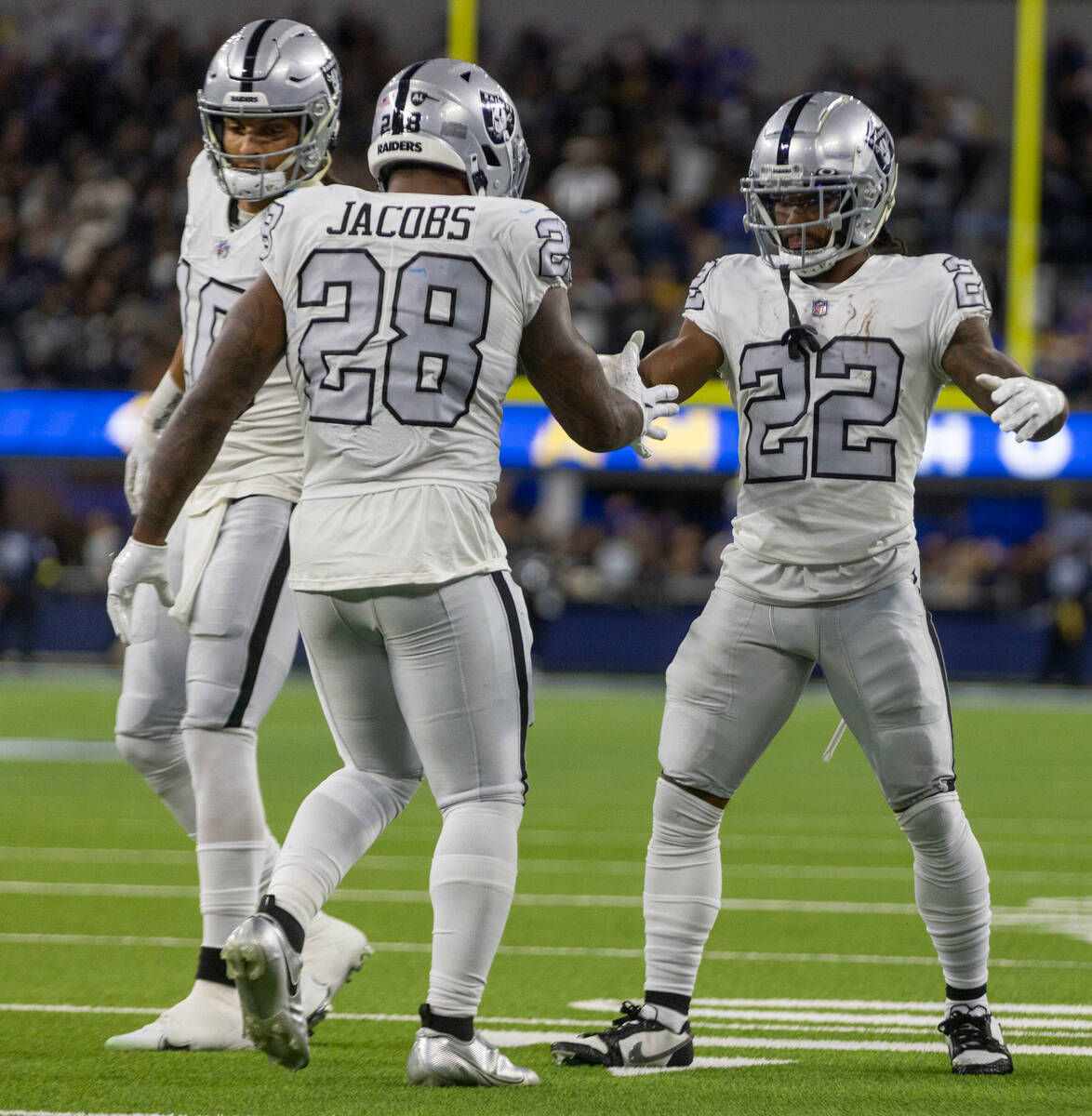 Raiders running back Josh Jacobs (28) celebrates his touchdown with wide receiver Mack Hollins ...