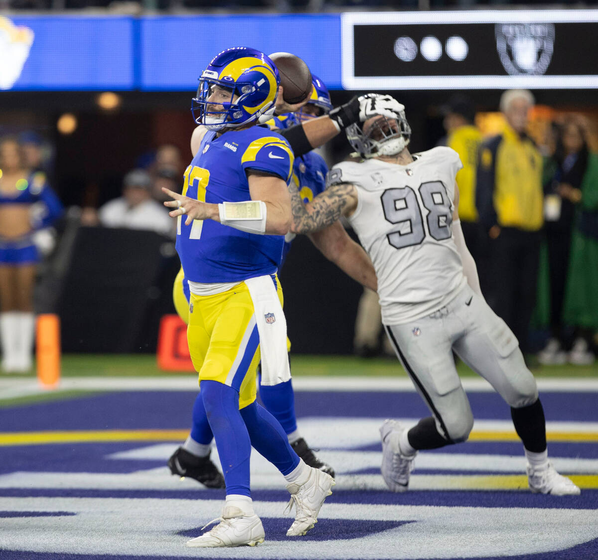 Los Angeles Rams quarterback Baker Mayfield (17) throws as Raiders defensive end Maxx Crosby (9 ...