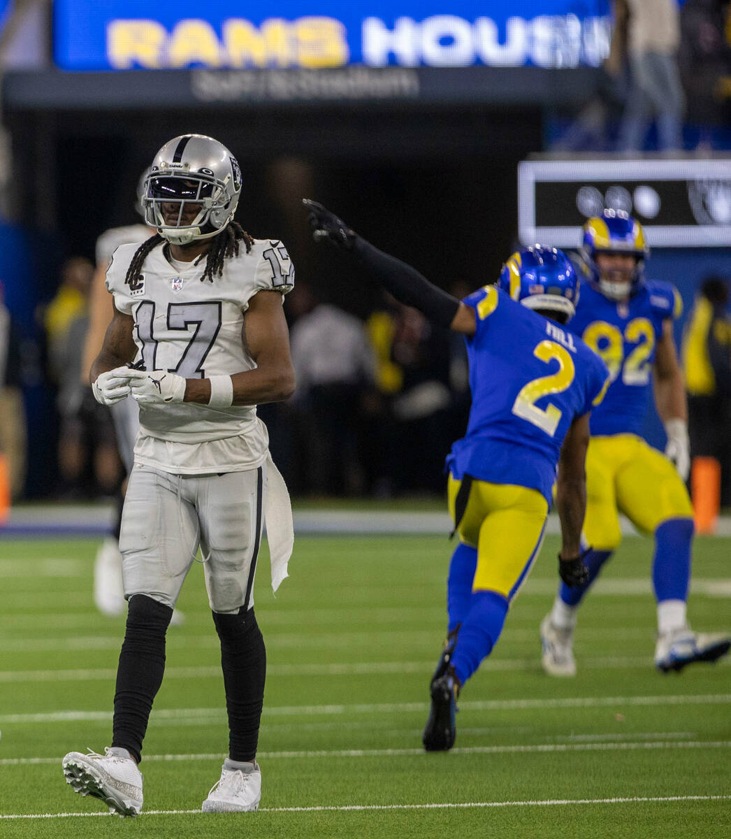 Raiders wide receiver Davante Adams (17) walks off the field as Los Angeles Rams cornerback Tro ...