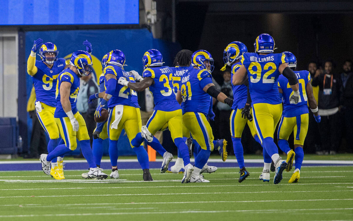 The Los Angeles Rams celebrate their win with Los Angeles Rams cornerback Troy Hill (2) who int ...