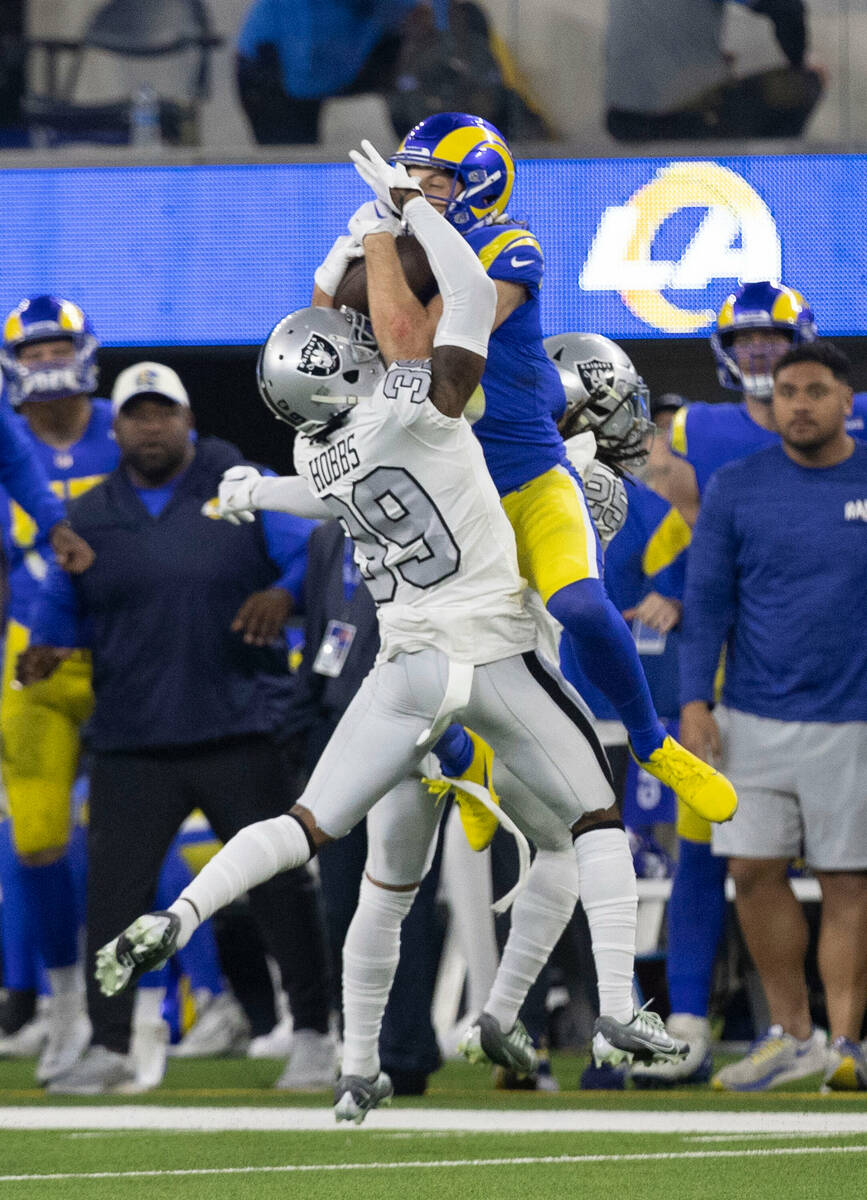 Los Angeles Rams wide receiver Ben Skowronek (18) makes a catch over Raiders cornerback Nate Ho ...