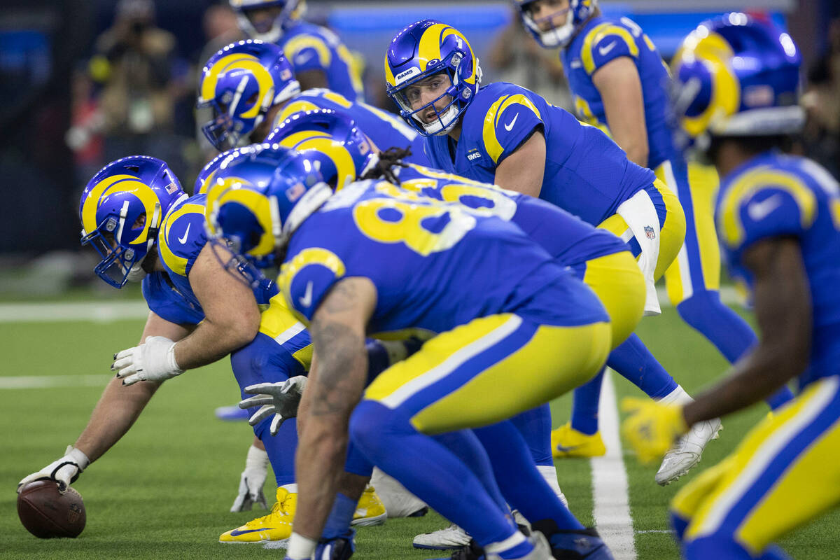 Los Angeles Rams quarterback Baker Mayfield (17) sets up under the line of scrimmage during the ...