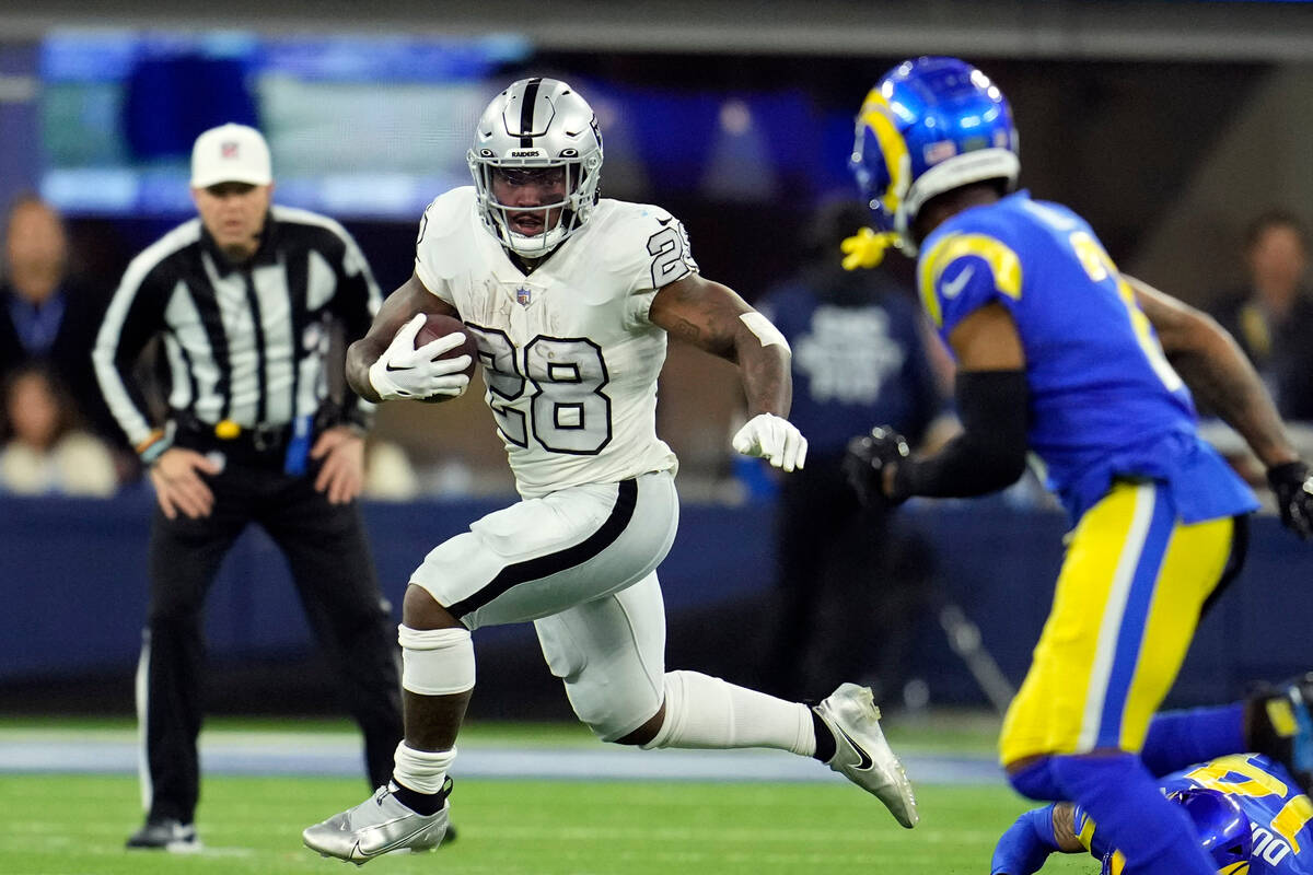 Las Vegas Raiders running back Josh Jacobs runs with the ball during the first half of an NFL f ...