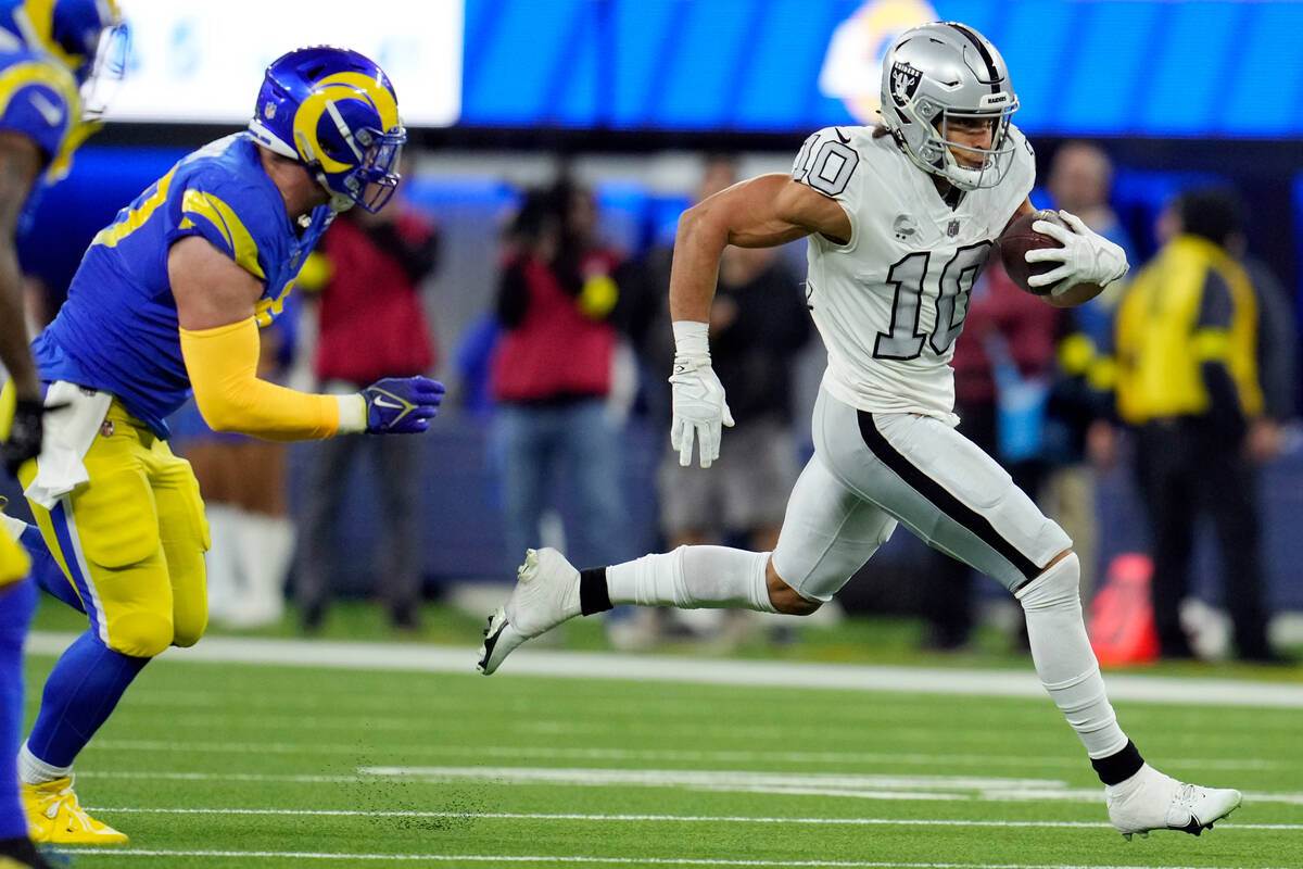 Las Vegas Raiders wide receiver Mack Hollins runs with the ball during the first half of an NFL ...