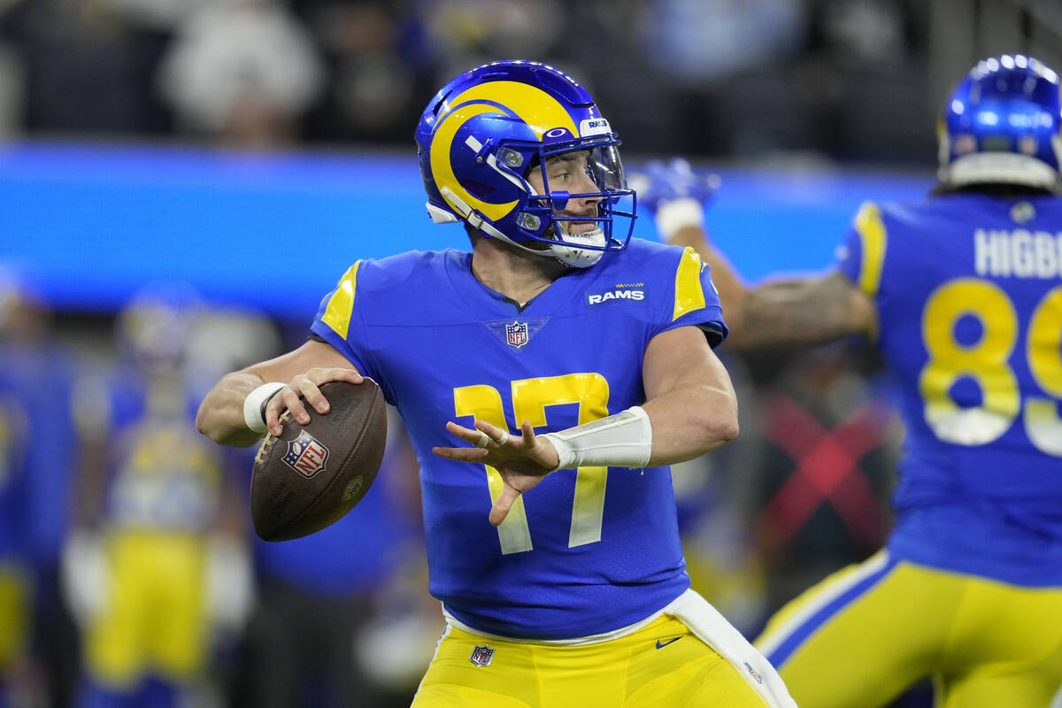 Los Angeles Rams quarterback Baker Mayfield throws a pass during the first half of an NFL footb ...