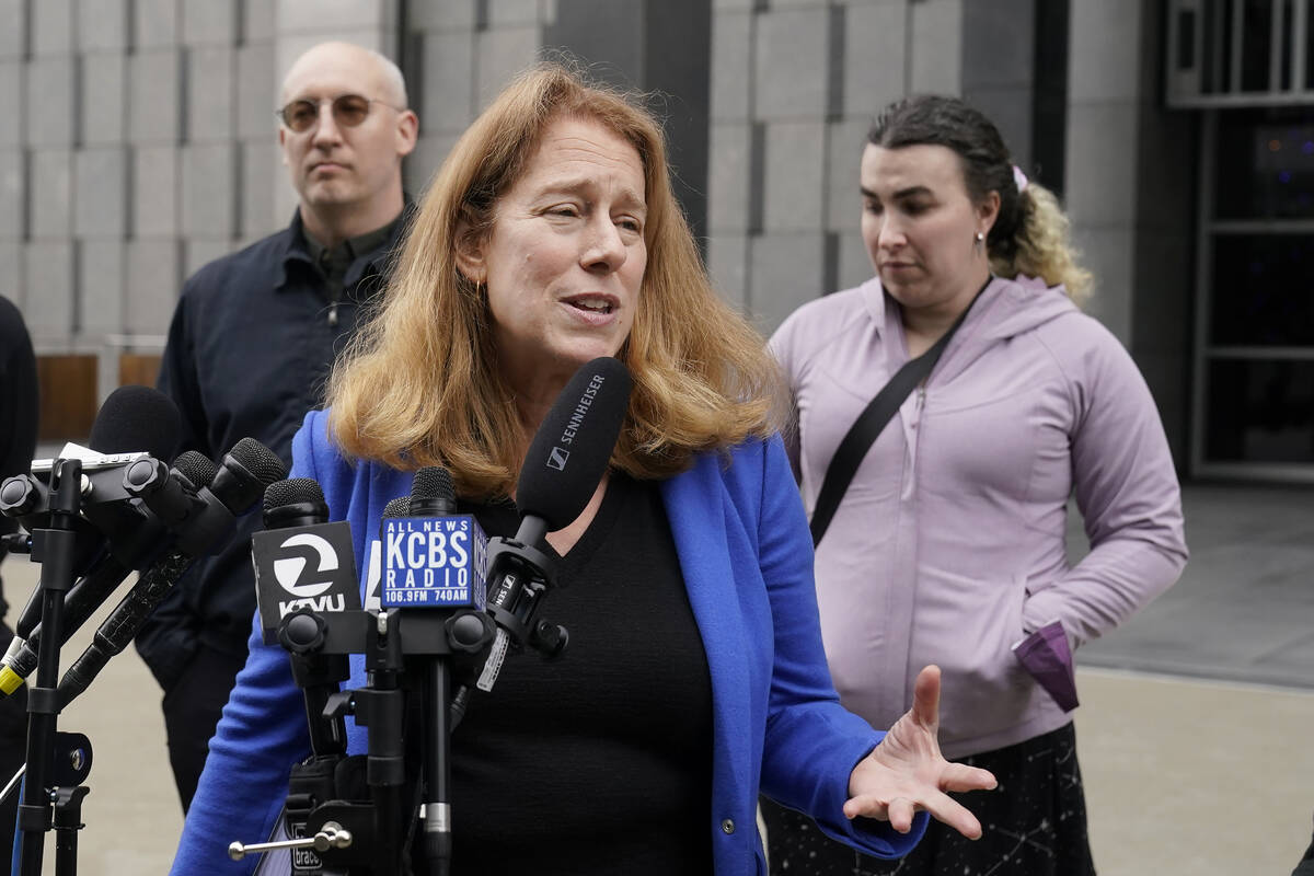 Attorney Shannon Liss-Riordan, foreground, speaks in front of former Twitter employees Dmitry B ...