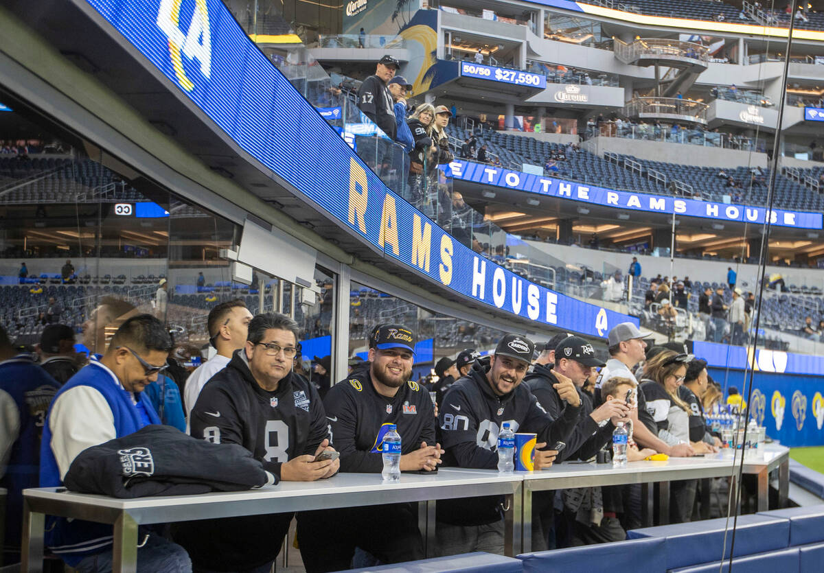 Raiders fans pose before an NFL game between the Raiders and the Los Angeles Rams at SoFi Stadi ...