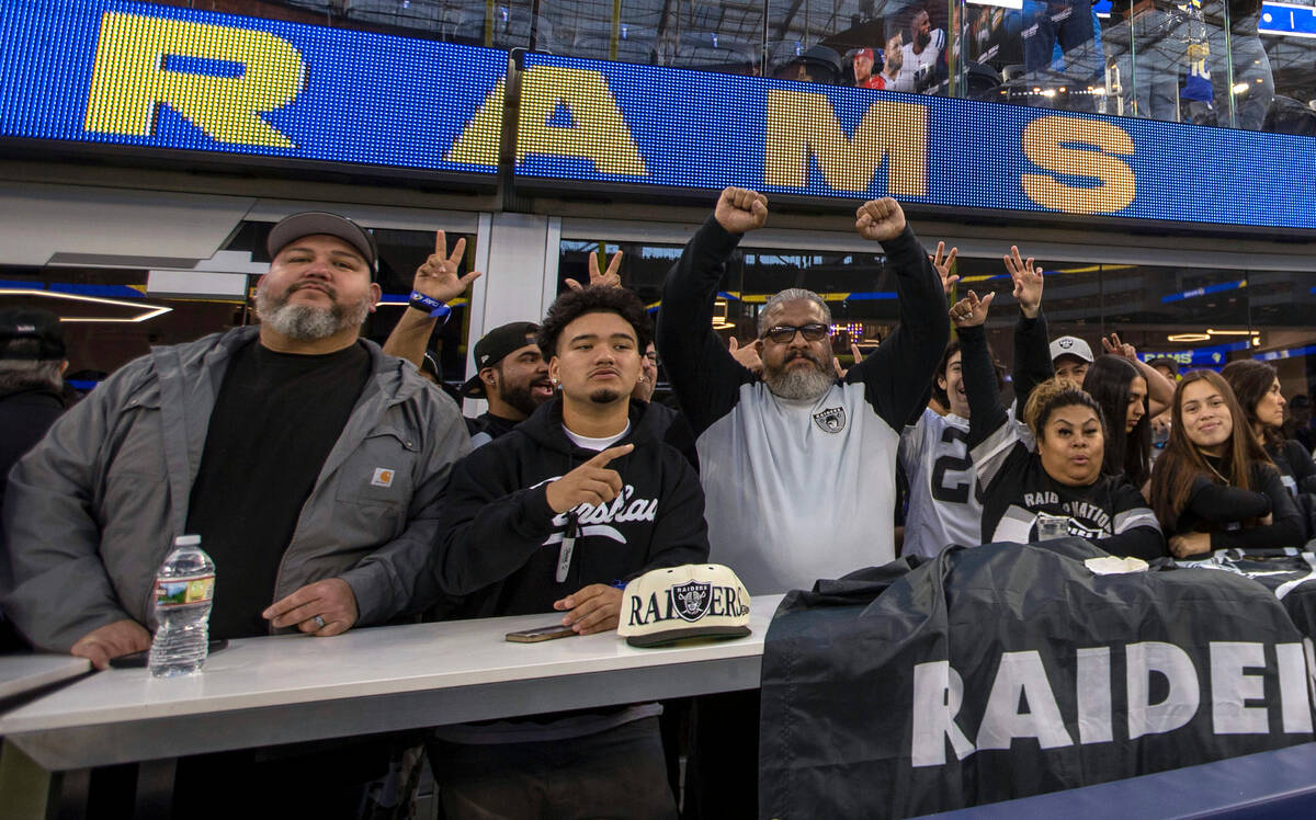 Raiders fans pose before an NFL game between the Raiders and the Los Angeles Rams at SoFi Stadi ...