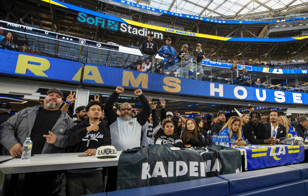 Raiders fans pose before an NFL game between the Raiders and the Los Angeles Rams at SoFi Stadi ...