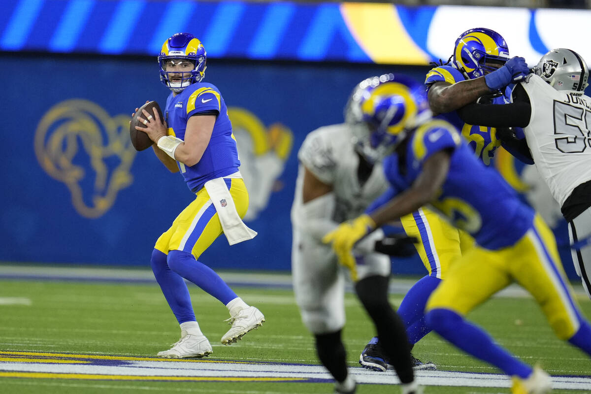 Los Angeles Rams quarterback Baker Mayfield looks to pass during the first half of an NFL footb ...