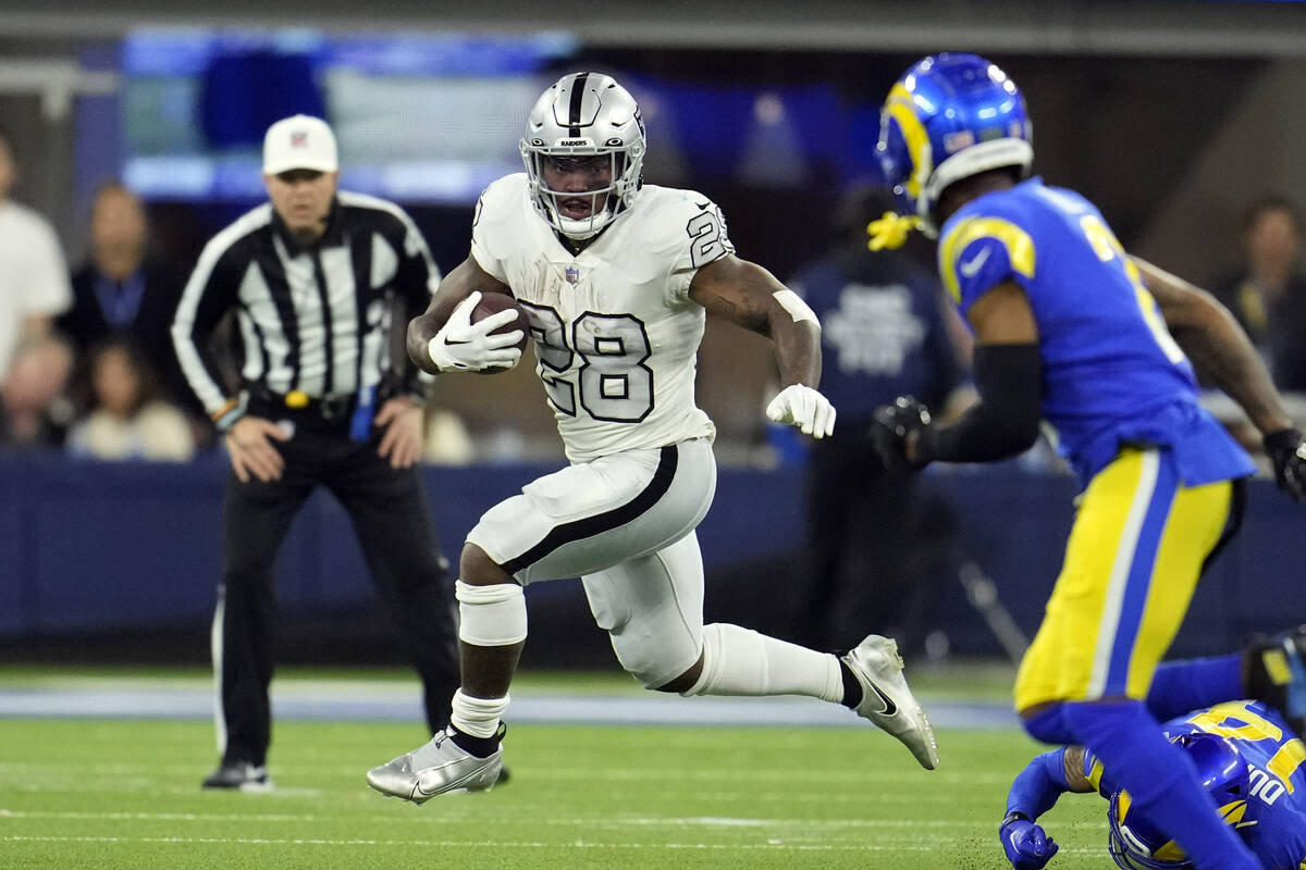 Las Vegas Raiders running back Josh Jacobs runs with the ball during the first half of an NFL f ...