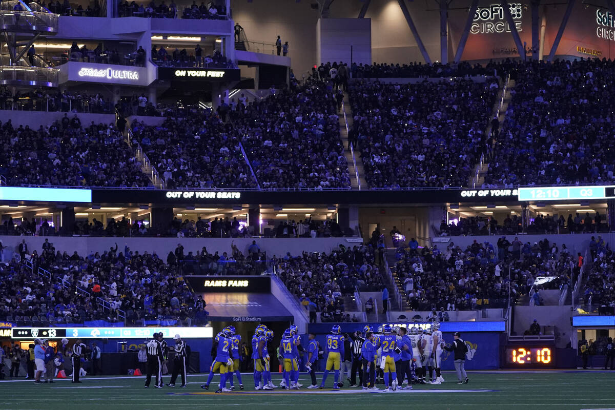 Fans hold lights from their phones during the second half of an NFL football game between the L ...