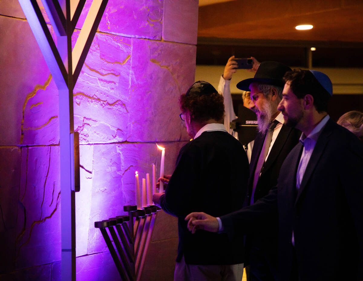 Commissioner Michael Naft Menorah goes to light the electric menorah as his father, Richard Naf ...