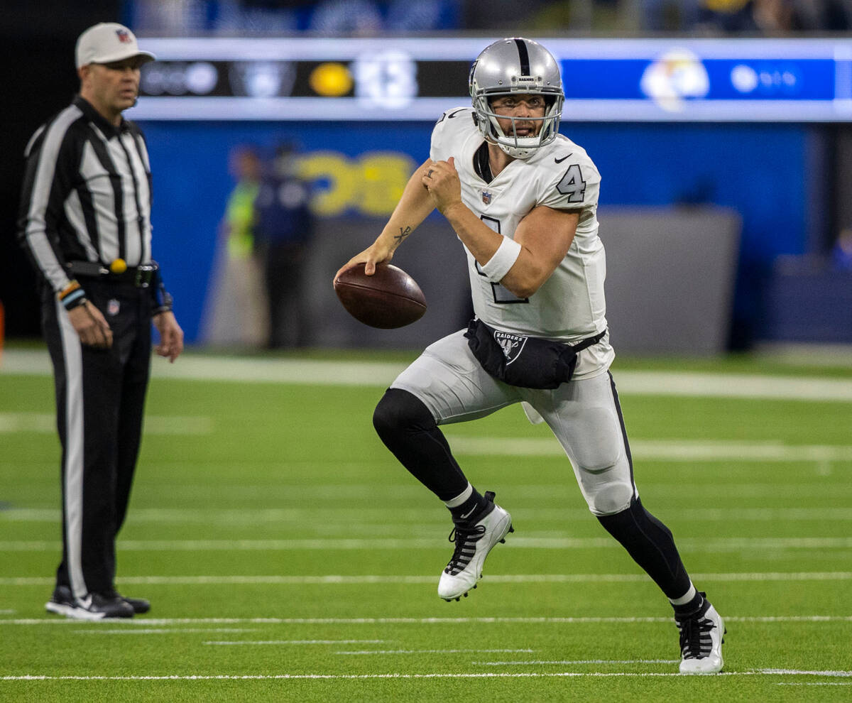 Raiders quarterback Derek Carr (4) scrambles with the football during the first half of an NFL ...