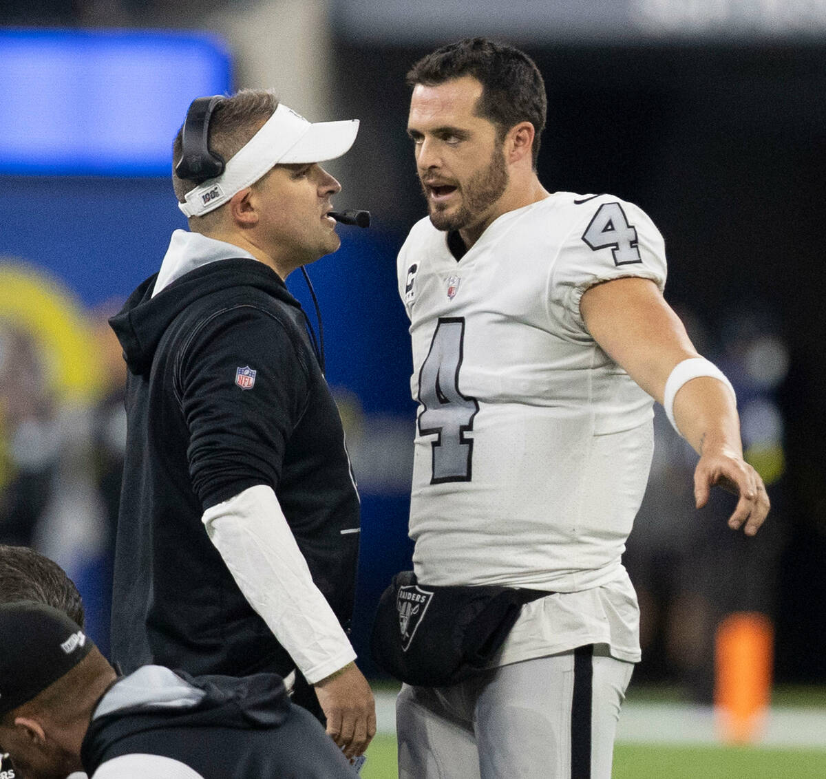 Raiders quarterback Derek Carr (4) and Raiders head coach Josh McDaniels speak during the secon ...