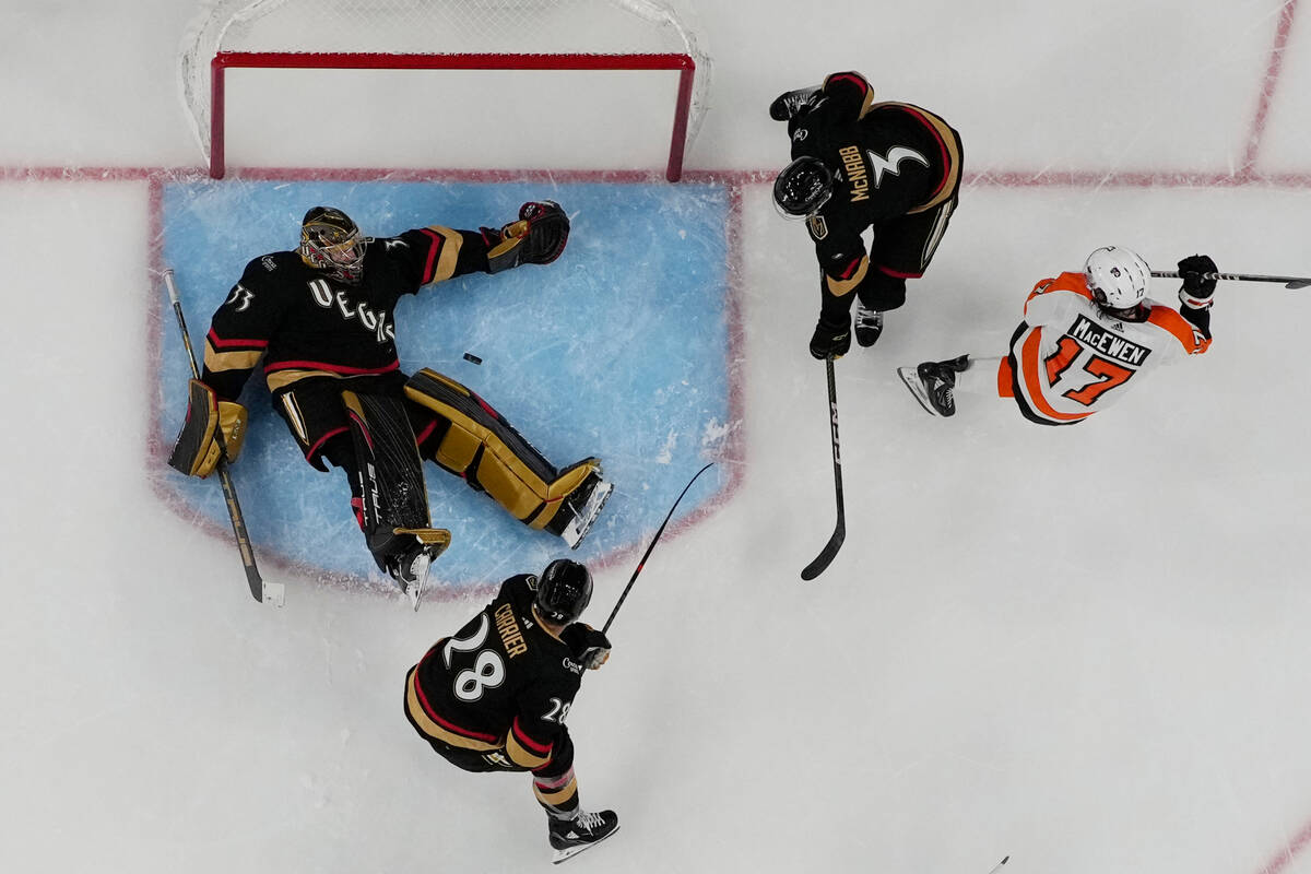 Vegas Golden Knights goaltender Adin Hill (33) blocks a shot by Philadelphia Flyers center Zack ...