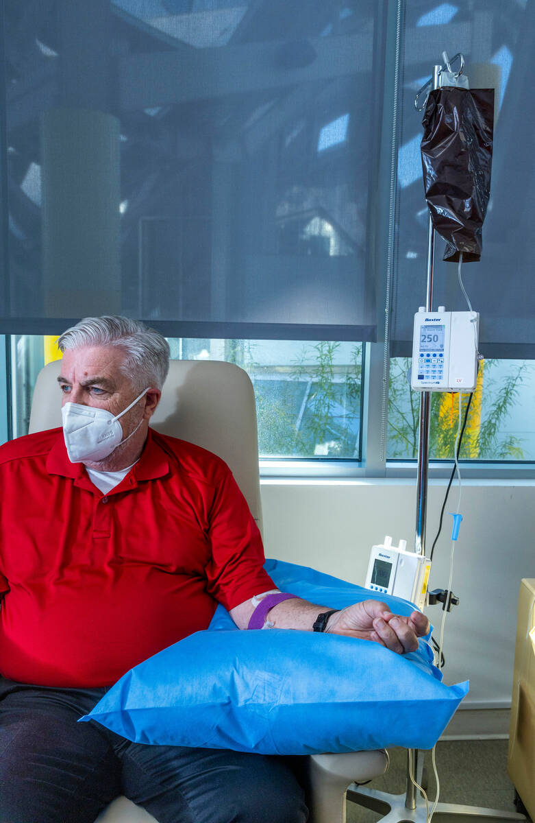 Clinical trial participant Bob Lathrop sits comfortably as he receives his next infusion of the ...