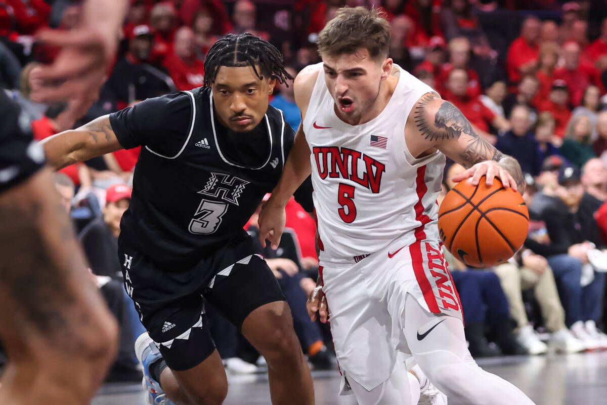 UNLV Rebels guard Jordan McCabe (5) drives the ball under pressure from Hawaii Warriors guard J ...