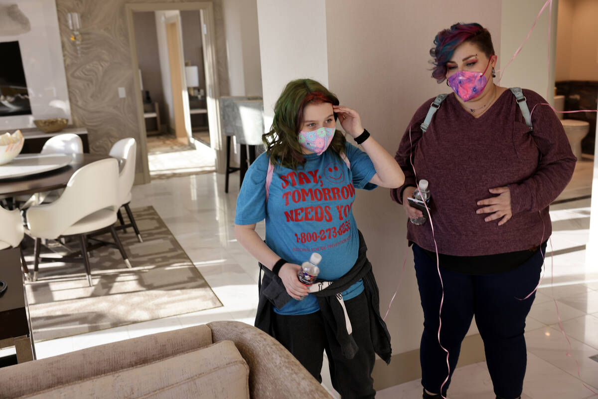 Harli Hecht, 10, who suffers from rare autoimmune conditions, reacts to seeing her hotel room w ...