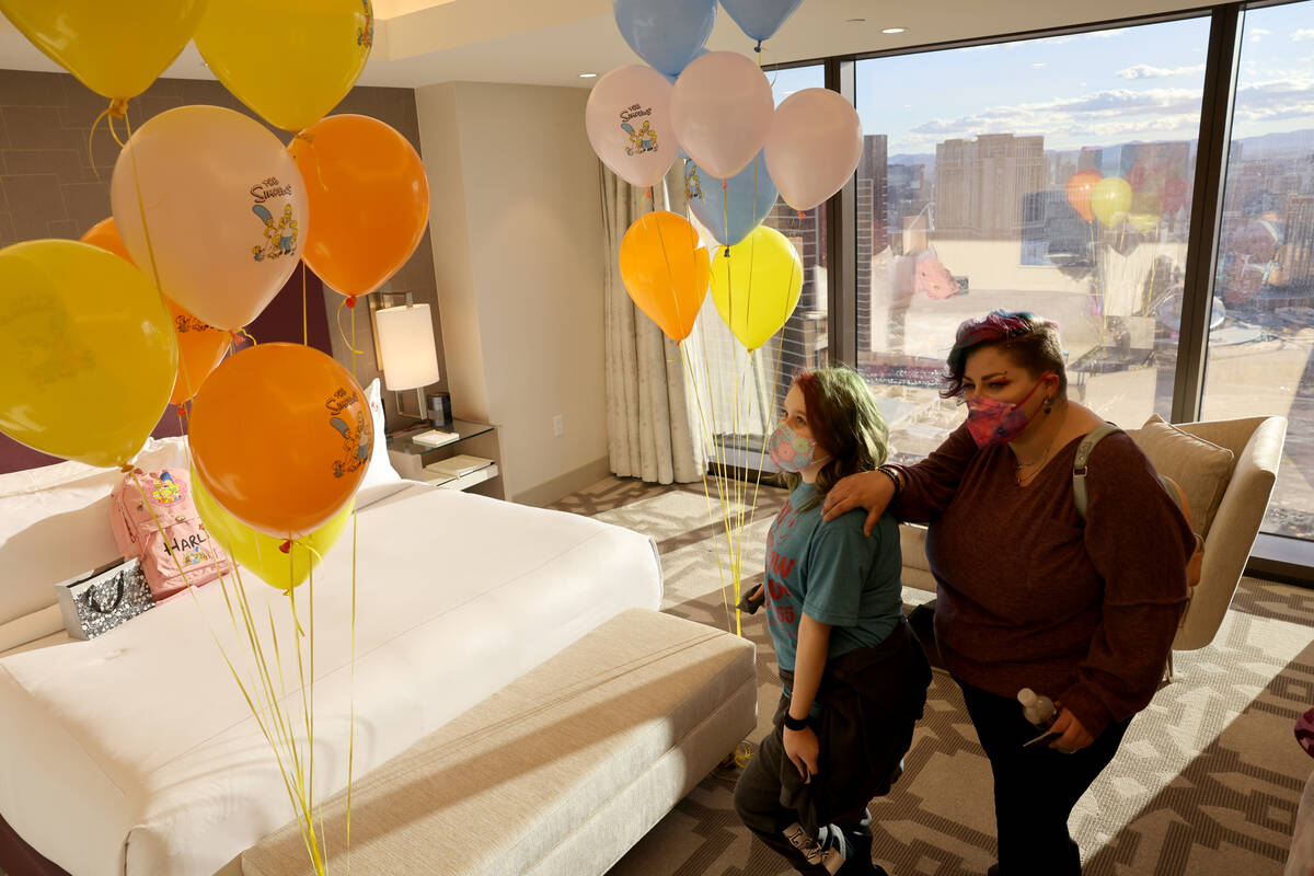 Harli Hecht, 10, who suffers from rare autoimmune conditions, reacts to seeing her hotel room w ...