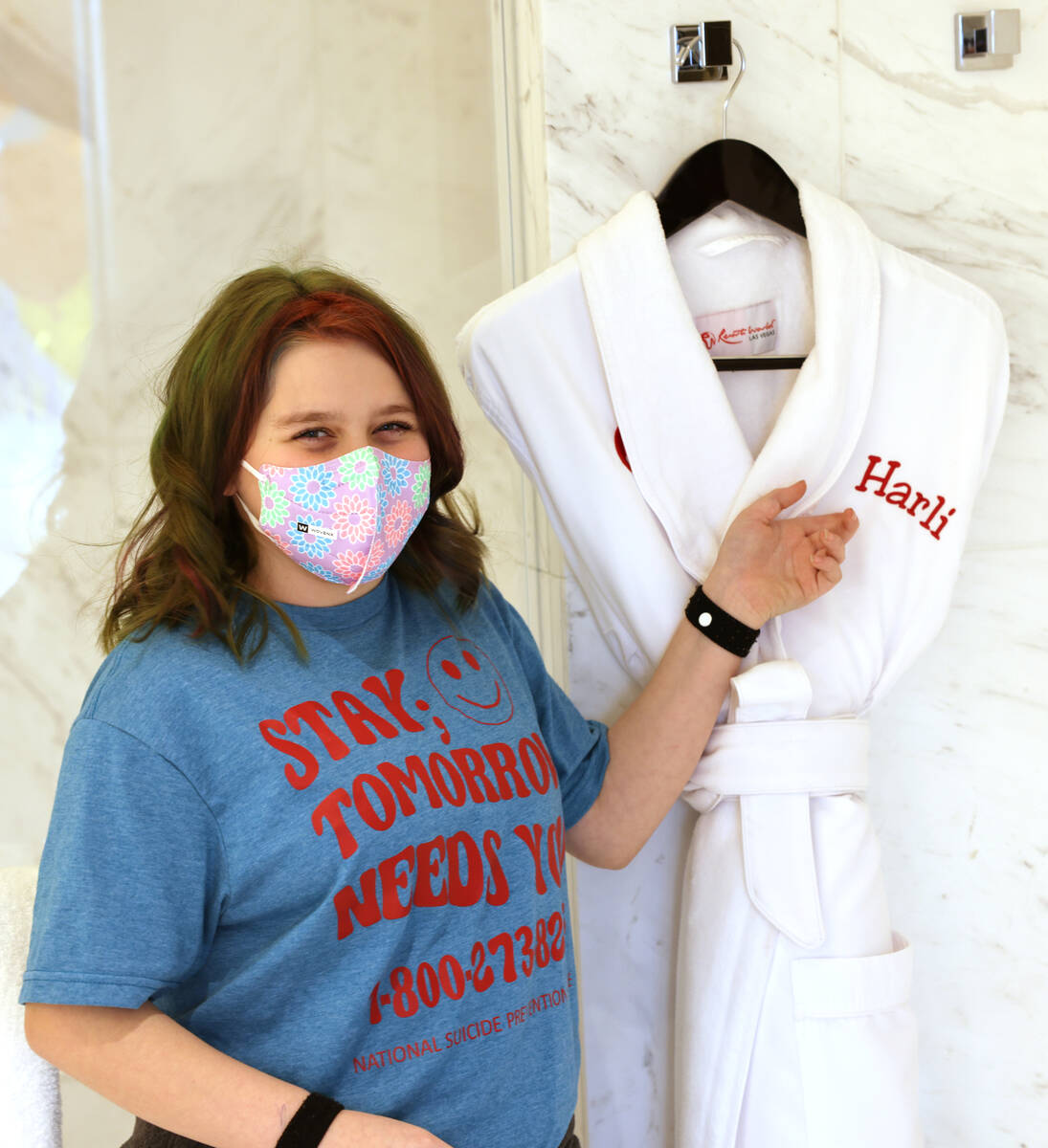 Harli Hecht, 10, who suffers from rare autoimmune conditions, reacts to seeing her hotel room w ...