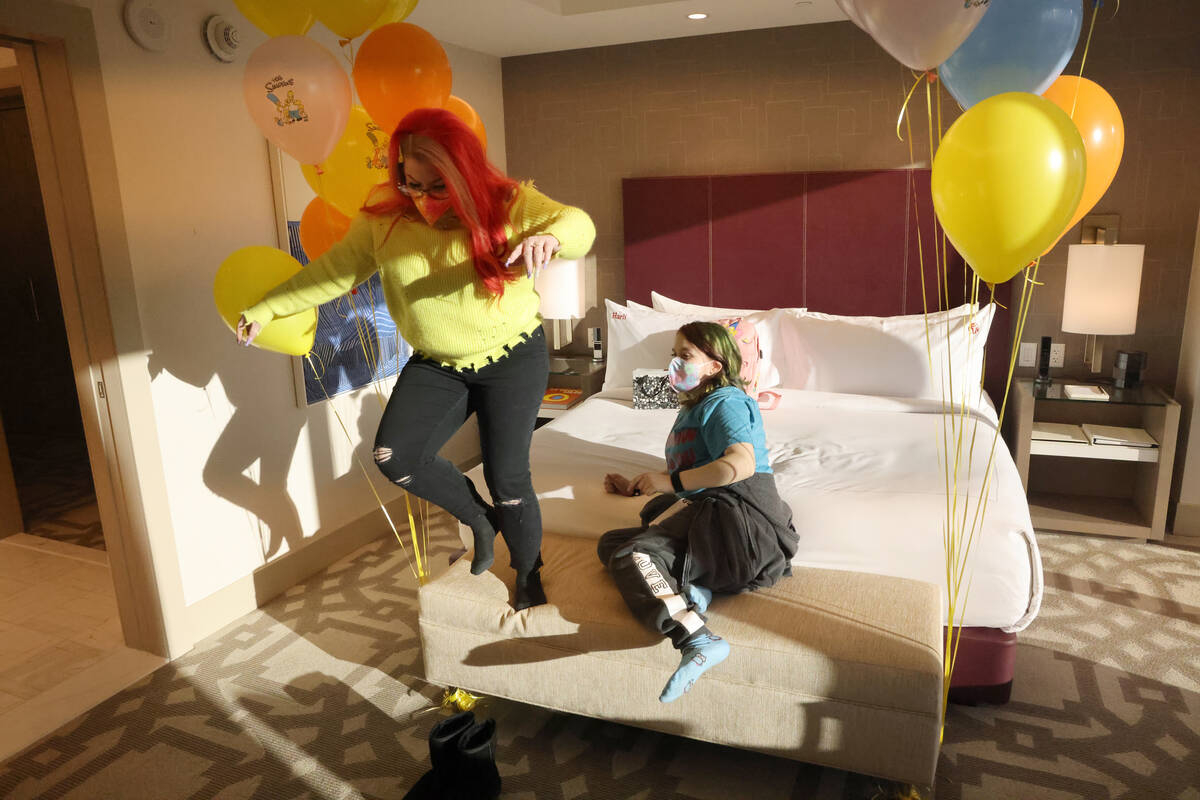 Harli Hecht, 10, who suffers from rare autoimmune conditions, reacts to seeing her hotel room w ...