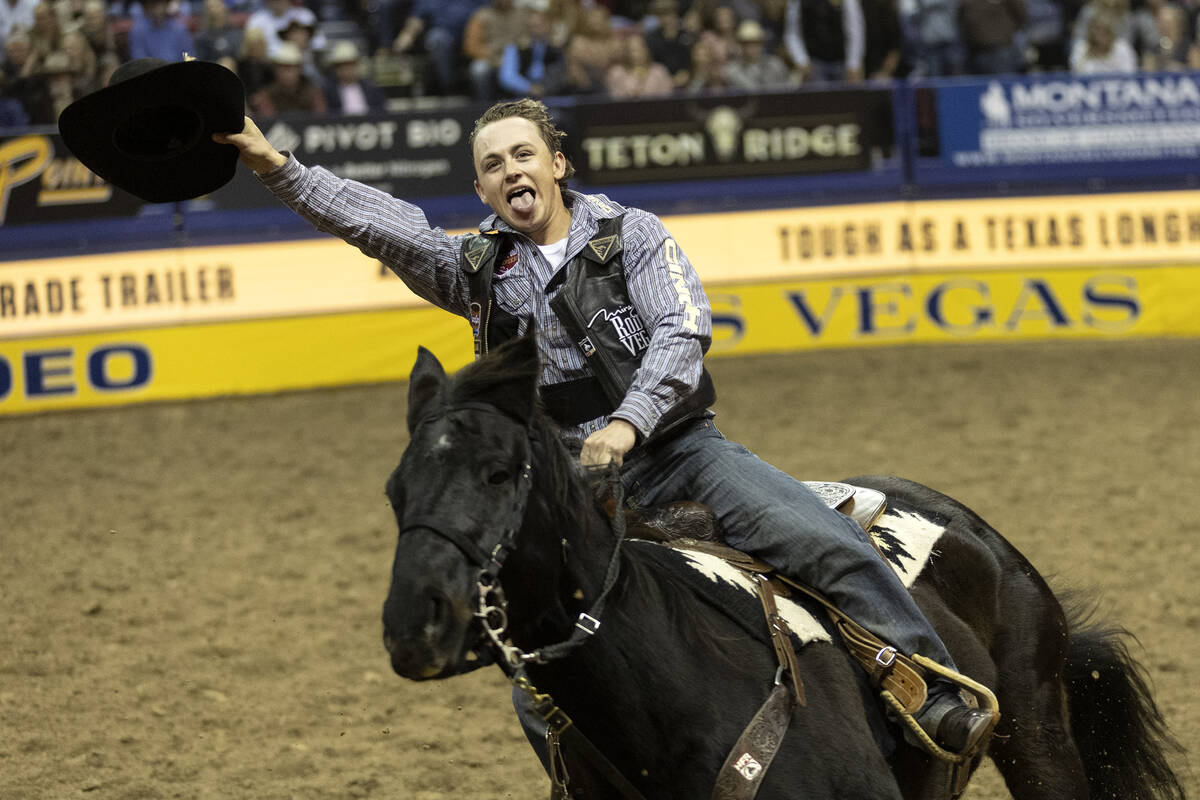 Logan Hay, of Wildwood, Alberta, Canada, celebrates after winning in the saddle bronc riding co ...