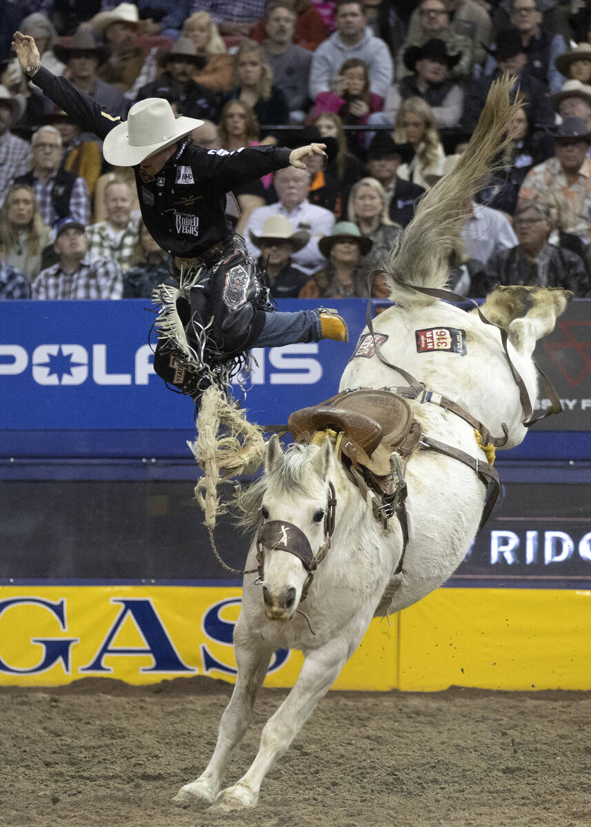 Dawson Hay, of Wildwood, Alberta, Canada, leaps from his horse as his eight seconds are up whil ...