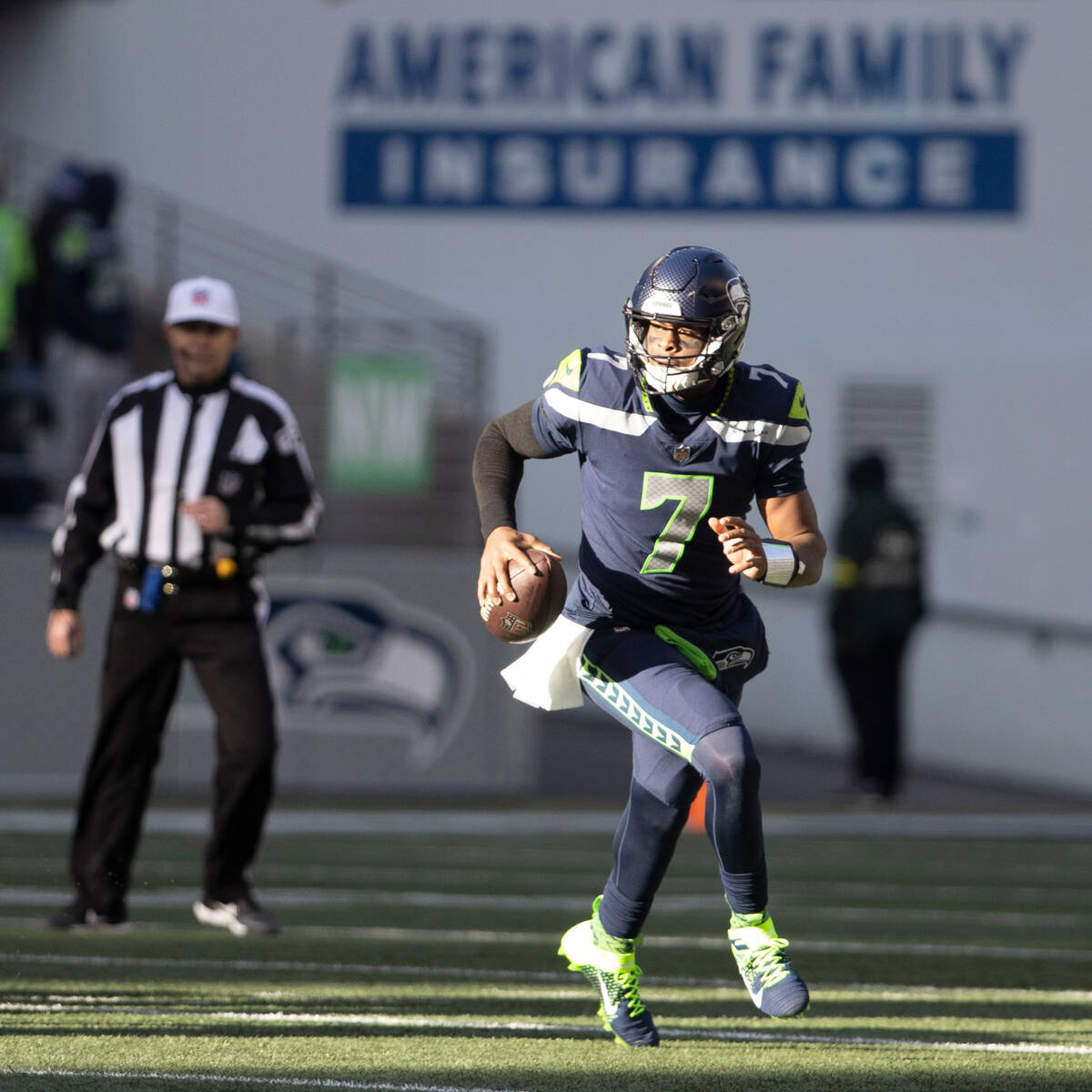 Seattle Seahawks quarterback Geno Smith (7) runs with the football during the first half of an ...