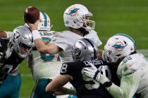 Miami Dolphins quarterback Ryan Fitzpatrick (14) prepares to throw the ball against Raiders dur ...