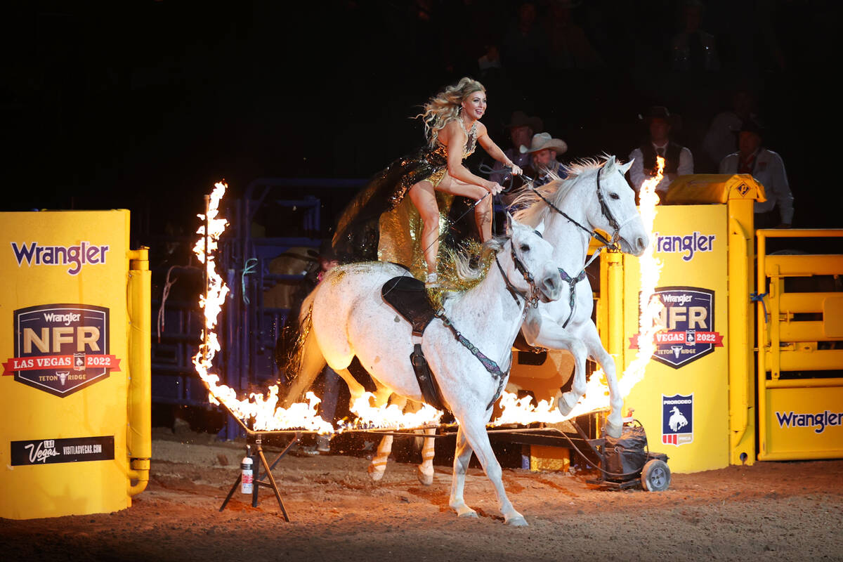 A performer enters the arena during round 10 of the 64th Wrangler National Finals Rodeo at the ...