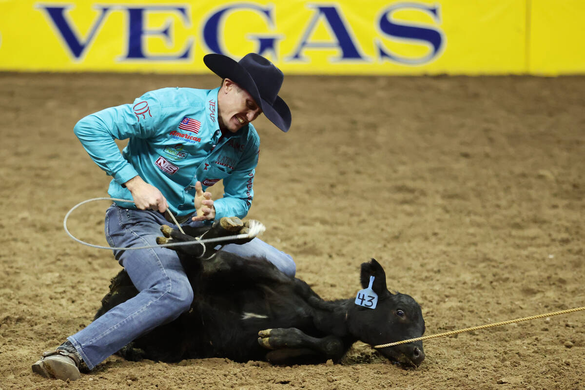 Tuf Cooper competes in the tie-down roping event during round 10 of the 64th Wrangler National ...
